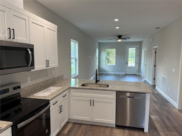 kitchen featuring white cabinetry, sink, kitchen peninsula, and stainless steel appliances