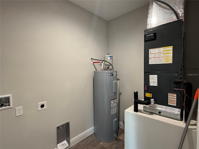 utility room featuring heating unit and water heater