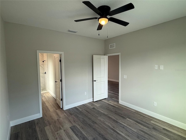 unfurnished bedroom with ceiling fan, dark hardwood / wood-style flooring, and ensuite bathroom