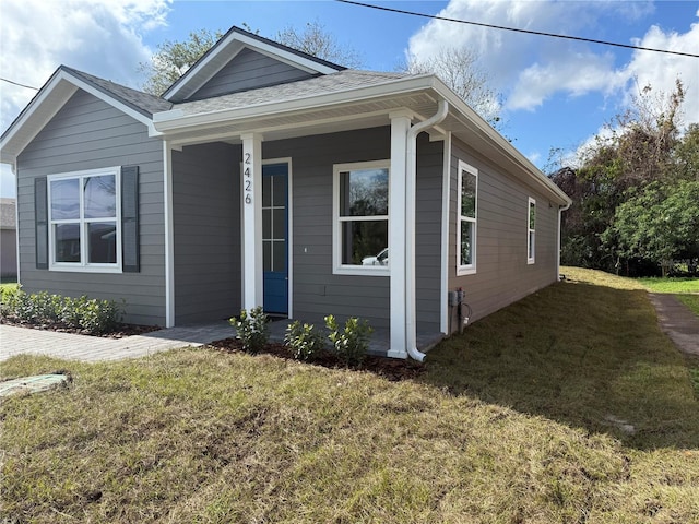 bungalow-style home with a front yard and a porch