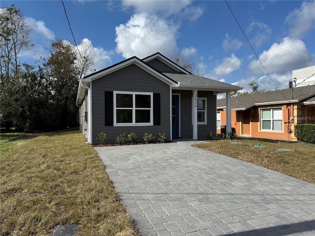 bungalow-style home featuring a front lawn