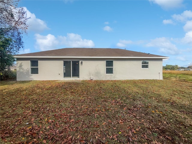 back of house featuring a yard