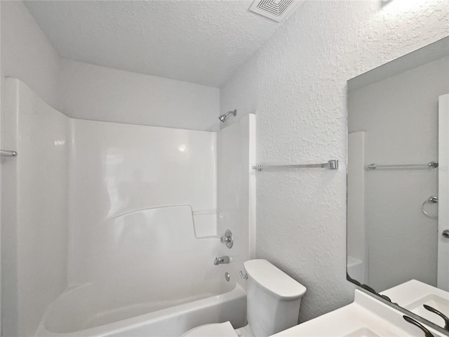 full bathroom featuring vanity, toilet, a textured ceiling, and shower / washtub combination