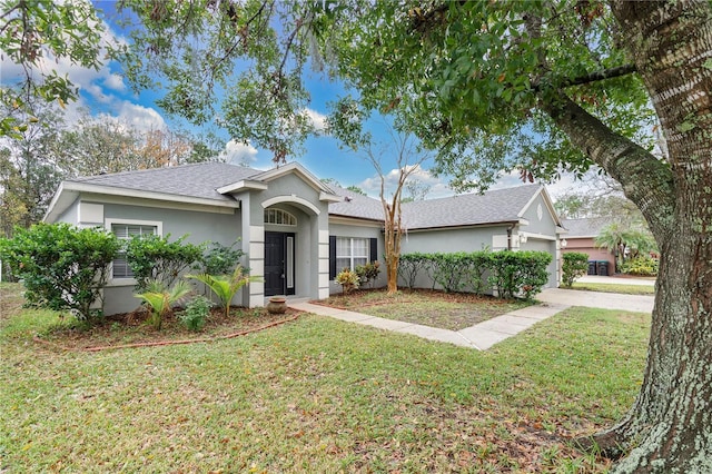 ranch-style house with a garage and a front lawn