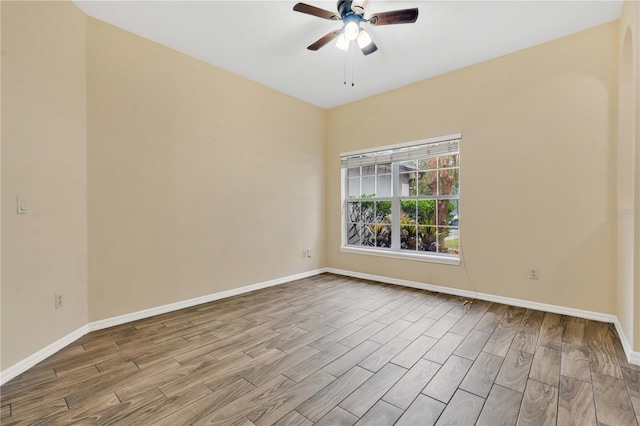 empty room with ceiling fan and light hardwood / wood-style floors