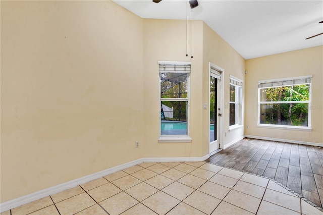 tiled empty room featuring ceiling fan