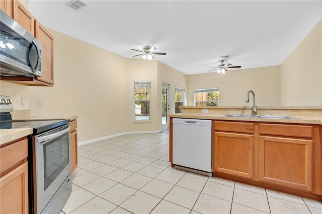 kitchen featuring ceiling fan, sink, light tile patterned floors, and appliances with stainless steel finishes