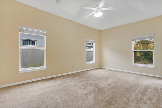 unfurnished room with light colored carpet and ceiling fan