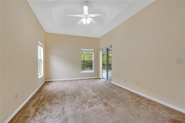 carpeted empty room featuring ceiling fan