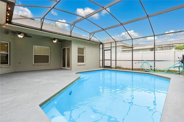 view of pool featuring a patio, ceiling fan, and a lanai