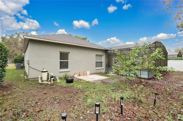 rear view of house featuring central AC and a lanai