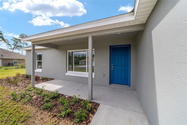 entrance to property featuring a porch