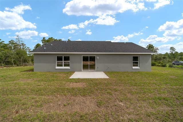 back of property featuring a patio and a lawn