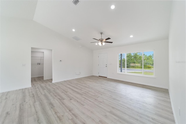 spare room featuring ceiling fan, light hardwood / wood-style flooring, and vaulted ceiling