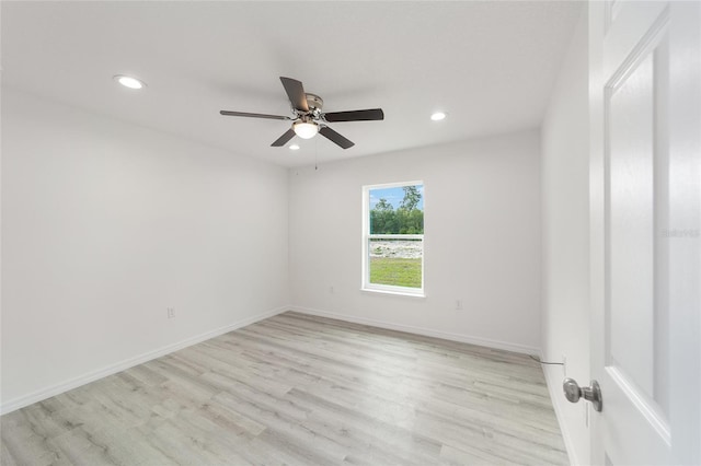 spare room featuring light hardwood / wood-style flooring and ceiling fan