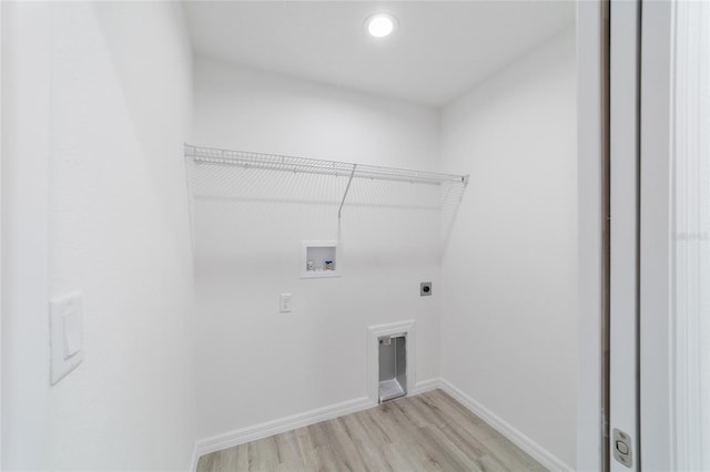 washroom featuring hookup for a washing machine, light hardwood / wood-style flooring, and electric dryer hookup