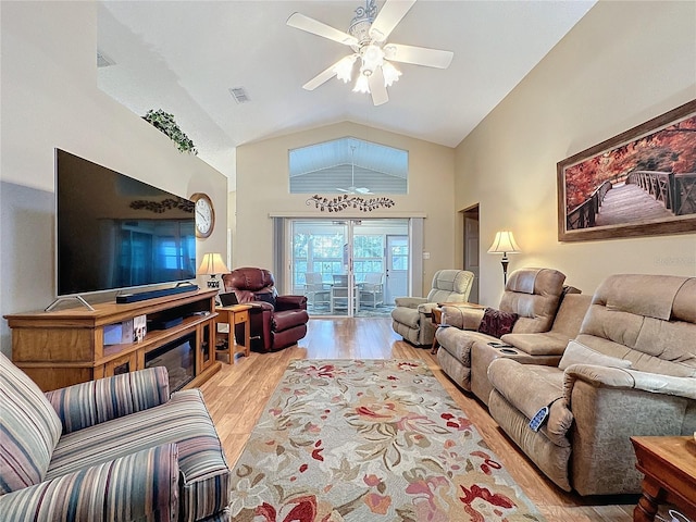 living room featuring light hardwood / wood-style flooring, ceiling fan, and lofted ceiling