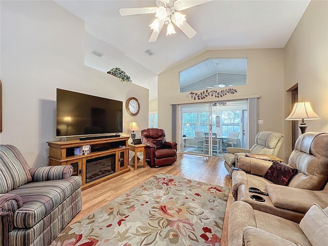 living room with light wood-type flooring, ceiling fan, and lofted ceiling