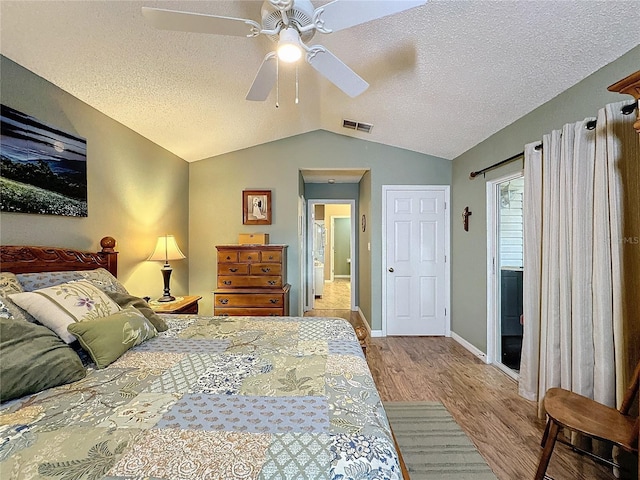 bedroom with hardwood / wood-style flooring, ceiling fan, lofted ceiling, and a textured ceiling