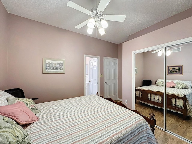 bedroom featuring ceiling fan, a textured ceiling, and hardwood / wood-style flooring