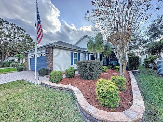 view of front of home featuring a garage and a front lawn