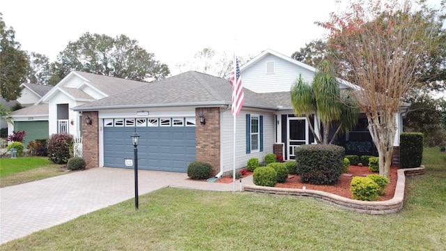 view of front of property with a garage and a front lawn