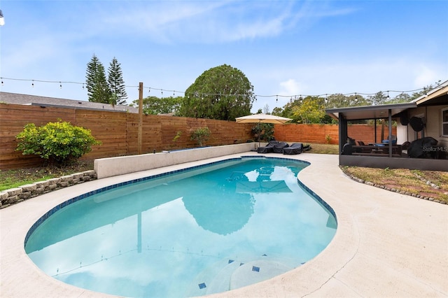 view of swimming pool featuring a sunroom