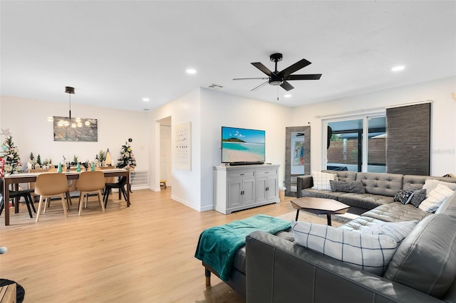 living room with light wood-type flooring and ceiling fan