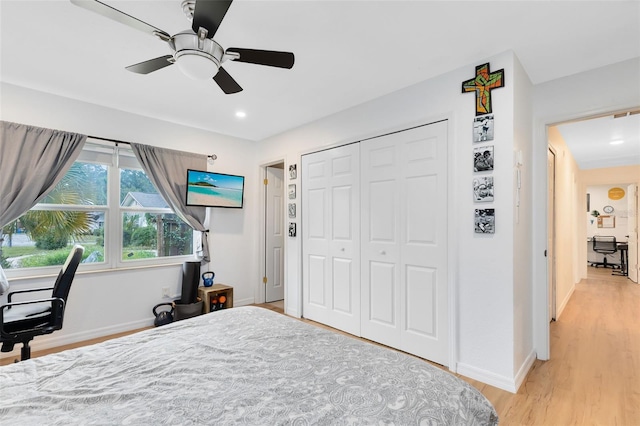 bedroom with light wood-type flooring, a closet, and ceiling fan