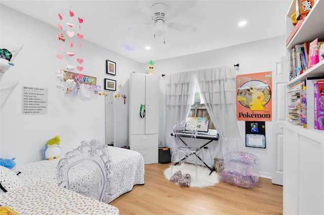 bedroom with ceiling fan and hardwood / wood-style flooring