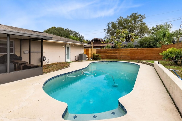 view of swimming pool with cooling unit and a patio area