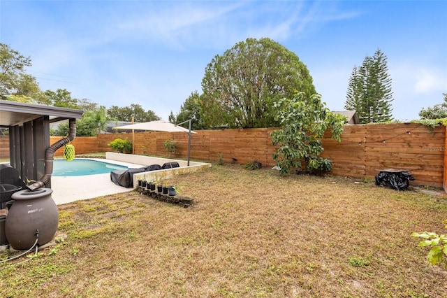 view of yard with a fenced in pool and a sunroom