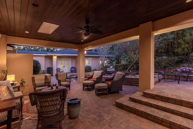 view of patio featuring ceiling fan, an outdoor hangout area, and french doors