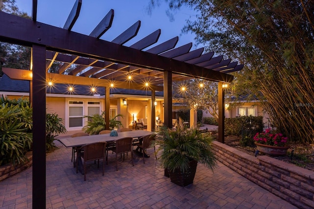 patio terrace at dusk featuring a pergola