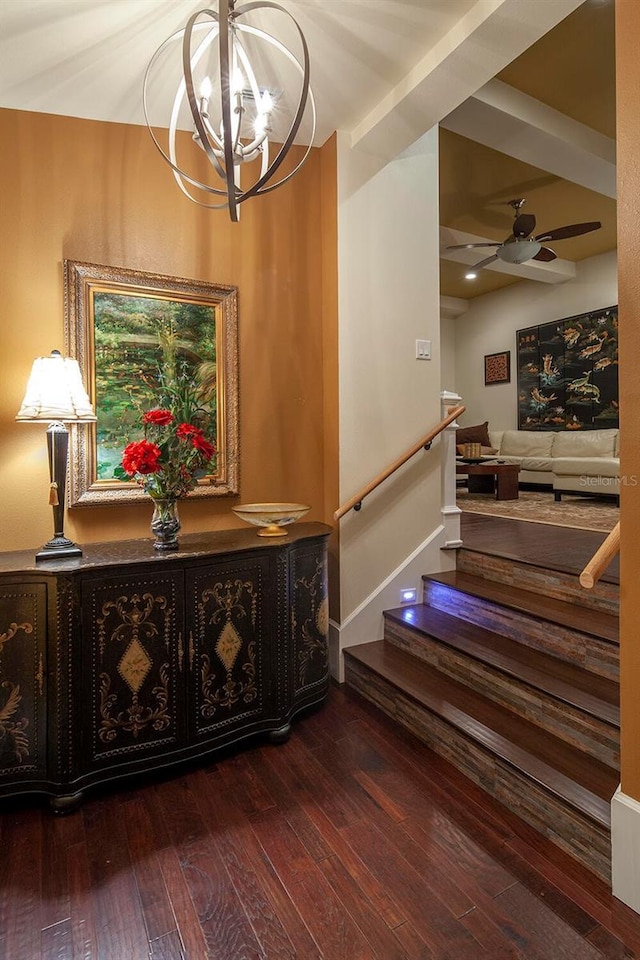 interior space featuring wood-type flooring and ceiling fan with notable chandelier