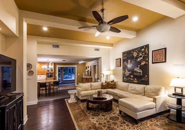 living room featuring dark hardwood / wood-style floors and ceiling fan with notable chandelier