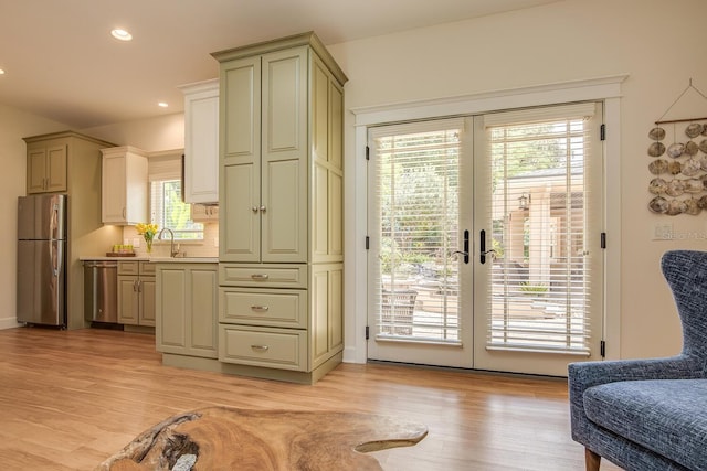 entryway with french doors, light hardwood / wood-style floors, and sink