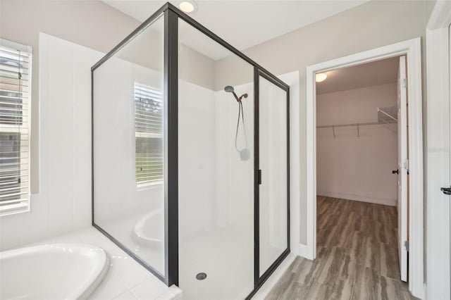 bathroom featuring independent shower and bath and wood-type flooring