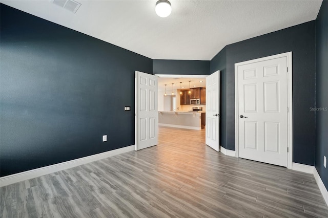 unfurnished bedroom featuring wood-type flooring