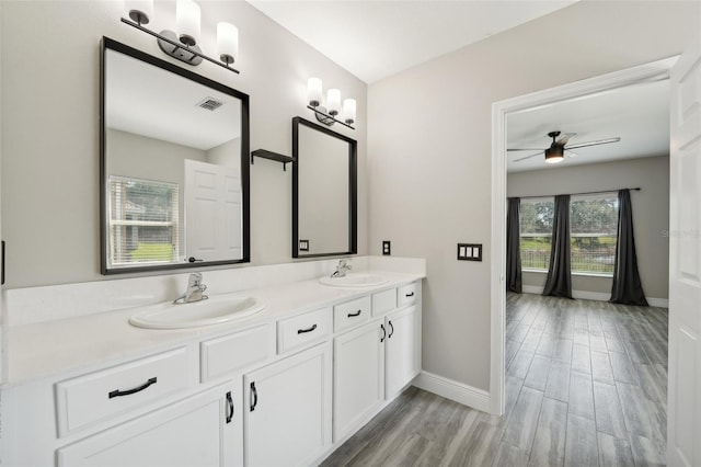 bathroom with hardwood / wood-style floors, vanity, and ceiling fan