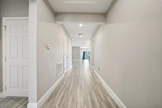 corridor with light wood-type flooring