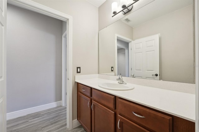 bathroom with vanity and hardwood / wood-style flooring