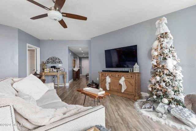 living room with hardwood / wood-style flooring and ceiling fan