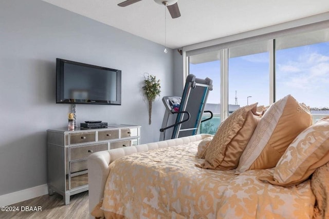 bedroom with ceiling fan and light wood-type flooring