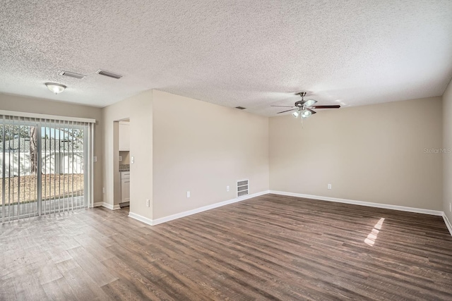 empty room featuring a textured ceiling, ceiling fan, and dark hardwood / wood-style floors