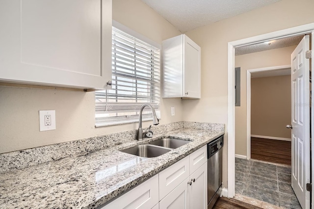 kitchen featuring dishwasher, white cabinets, light stone countertops, a textured ceiling, and sink