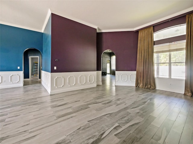 unfurnished living room featuring ornamental molding and light hardwood / wood-style flooring