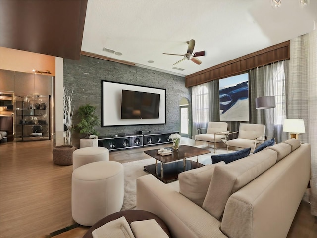 living room with hardwood / wood-style flooring and ceiling fan