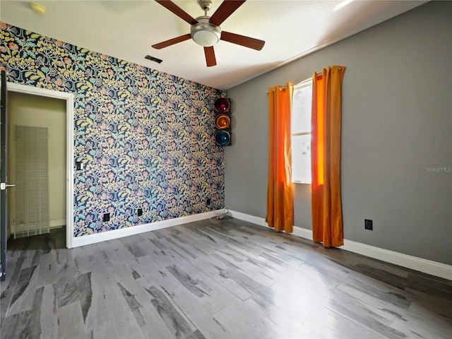 empty room featuring hardwood / wood-style flooring and ceiling fan