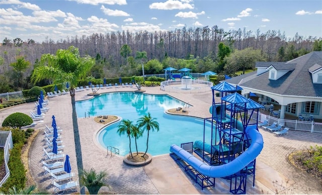 view of pool with a patio area and a water slide